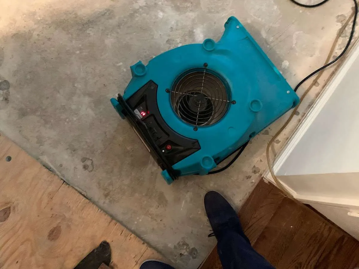 Air mover drying subfloor during Leak Detection & Repair in Evanston